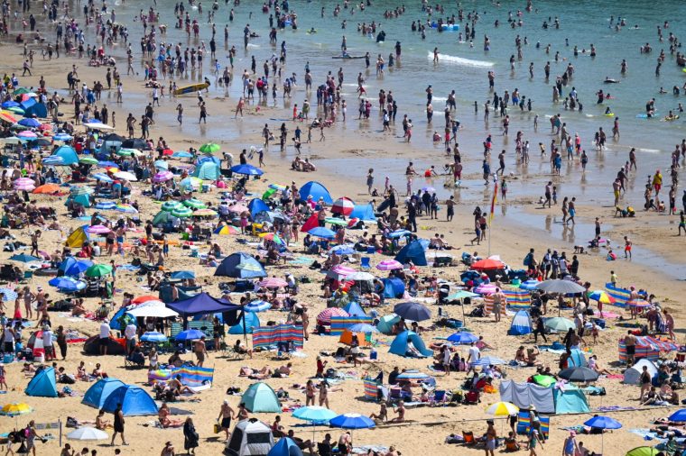 BOURNEMOUTH, ENGLAND - MAY 25: Visitors enjoy the hot weather at Bournemouth beach, on May 25, 2026 in Bournemouth, England. An exceptional bank holiday heatwave is currently bringing record-breaking weather to England with temperatures forecast to climb into the low 30s by Monday. The intense high pressure has prompted the UK Health Security Agency (UKHSA) to issue rare, amber heat alerts across multiple regions due to the health risks for vulnerable people and extreme UV levels. (Photo by Finnbarr Webster/Getty Images)