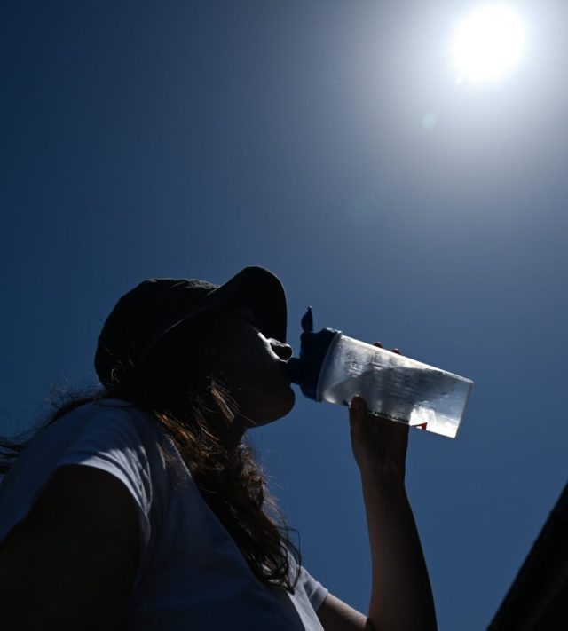 LONDON, UNITED KINGDOM - MAY 26: A woman tries to cool down by drinking water during a heatwave in London, United Kingdom on May 26, 2026. The British capital is experiencing historically high temperatures for the month of May. (Photo by Rasid Necati Aslim/Anadolu via Getty Images)