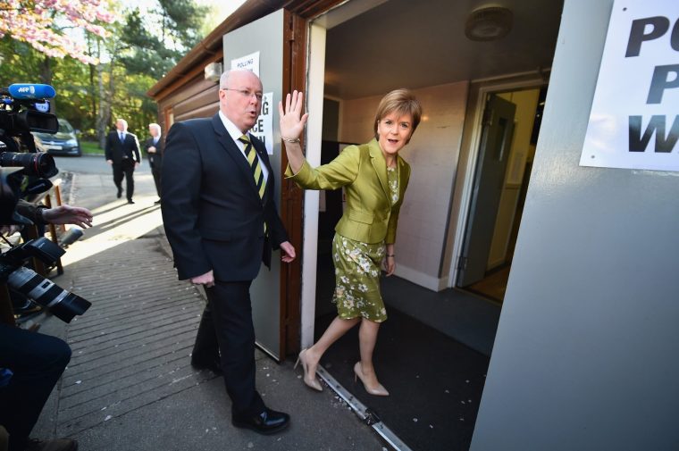 GLASGOW, SCOTLAND - MAY 07: First Minister of Scotland and leader of the SNP Nicola Sturgeon, votes with her husband Peter Murrell on May 7, 2015 in Glasgow, Scotland. People across Scotland have begun casting their votes in the UK general election, with fifty nine Scottish seats up for grabs. (Photo by Jeff J Mitchell/Getty Images)