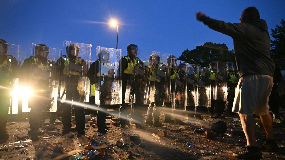 TOPSHOT - Protestors demonstrate with police officers near Portswood Police Station in Southampton, southern England, on June 2, 2026, during a protest held in reaction to the Police's handling of the detention of victim Henry Nowak, following the conviction of his murderer Vickrum Digwa. Body camera footage of dying student Henry Nowak, who was handcuffed by British police after being stabbed by Sikh man Vickrum Digwa, and falsely accused of racially abusing his murderer sparked outrage Tuesday. (Photo by JUSTIN TALLIS / AFP via Getty Images)