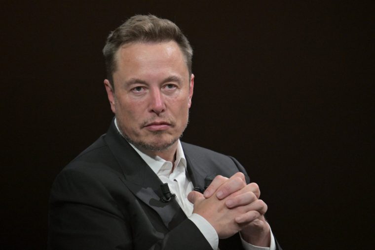 (FILES) SpaceX, Twitter and electric car maker Tesla CEO Elon Musk looks on as he speaks during his visit at the Vivatech technology startups and innovation fair at the Porte de Versailles exhibition center in Paris, on June 16, 2023. SpaceX, the rocket and satellite company led by billionaire Elon Musk, aims to raise approximately $75 billion in a record initial public offering, the company said in a regulatory filing on June 3, 2026. SpaceX said it will put up for sale 555,555,555 shares at an initial price of $135 each. Should the public offering proceed, Musk's company would shatter the fundraising record previously held by oil giant Saudi Aramco, which raised $25.6 billion in 2019. (Photo by Alain JOCARD / AFP via Getty Images)