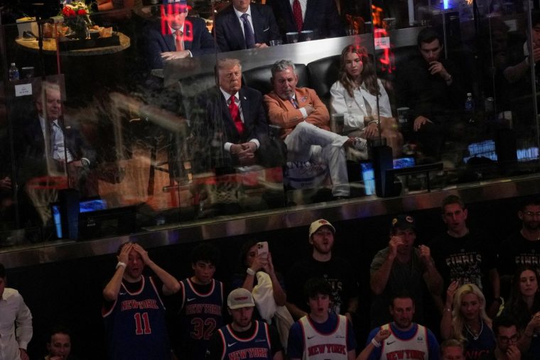 U.S. President Donald Trump,his granddaughter Kai Trump, and New York Knicks owner James Dolan, attend Game 3 of the NBA Finals at Madison Square Garden in New York City, New York, U.S., June 8, 2026. REUTERS/Nathan Howard REFILE - CORRECTING FROM 