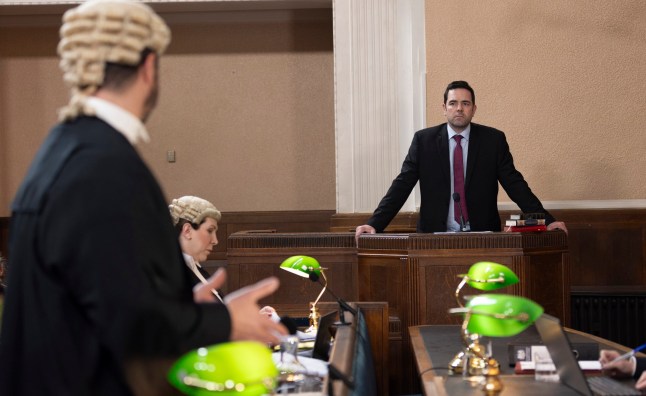 Ben Driscoll stood in the witness box looking at a barrister in Coronation Street