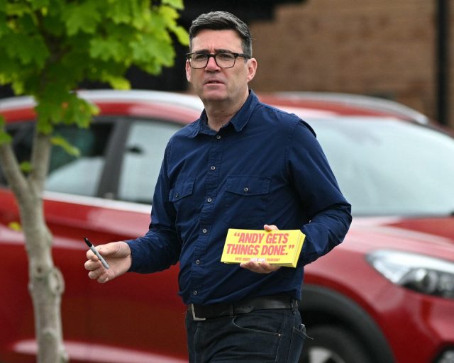 Andy Burnham, Labour's candidate in the forthcoming Makerfield by-election on June 18, canvasses voters in Hindley, north-west England on June 16, 2026. (Photo by Oli SCARFF / AFP via Getty Images)