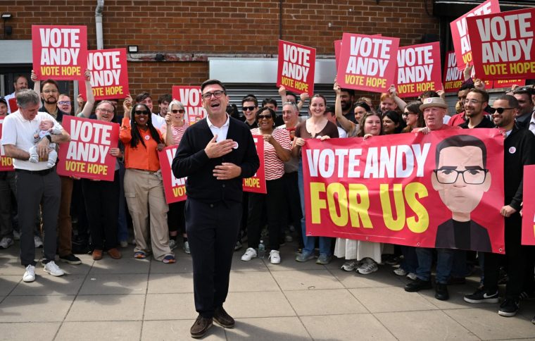TOPSHOT - Labour party candidate Andy Burnham addresses supporters outside the Labour party campaign office in Ashton in Makerfield, northwest England, on June 18, 2026, as voters go to the polls to vote in the Makerfield by-election. Britain holds a unique vote on June 18 that could trigger the endgame for Labour leader Keir Starmer's beleaguered premiership, or win him a reprieve. (Photo by Oli SCARFF / AFP via Getty Images)