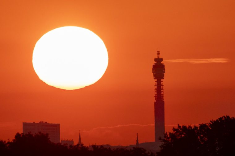 LONDON, ENGLAND - JUNE 19: The sun rises over central London viewed from Richmond Park on June 19, 2026 in London, England. Temperatures are set to rise today with a heatwave forecast to develop over the weekend, prompting yellow weather warnings and advice to stay hydrated. (Photo by Brook Mitchell/Getty Images)