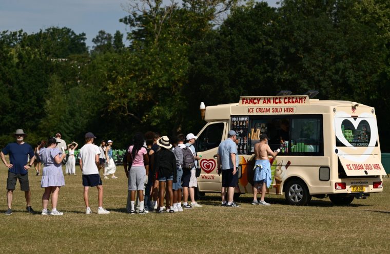 LONDON, ENGLAND - JULY 01: Spectators queue for ice cream, in the queue on day two of The Championships Wimbledon 2025 at All England Lawn Tennis and Croquet Club on July 01, 2025 in London, England. (Photo by Hannah Peters/Getty Images)