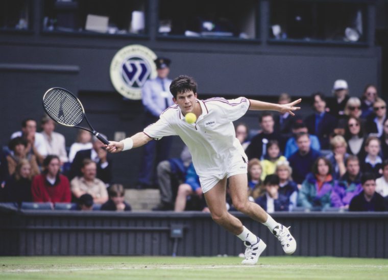 Tim Henman from Great Britain keeps his eyes on the tennis ball as he reaches to play a forehand return to Paul Haarhuis of the Netherlands during their Men's Singles Third Round match at the Wimbledon Lawn Tennis Championship on 28th June 1997 at the All England Lawn Tennis and Croquet Club in Wimbledon, London, England. Tim Henman won the match 6 - 7, 6 - 3, 6 - 2, 4 - 6, 14 - 12. (Photo by Gary M. Prior/Allsport/Getty Images)