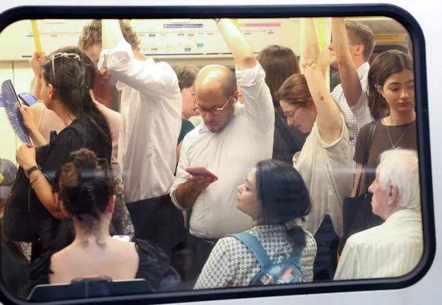 Commuters travel on a London Underground tube carriage, during a heatwave, in central London on June 24, 2026.
