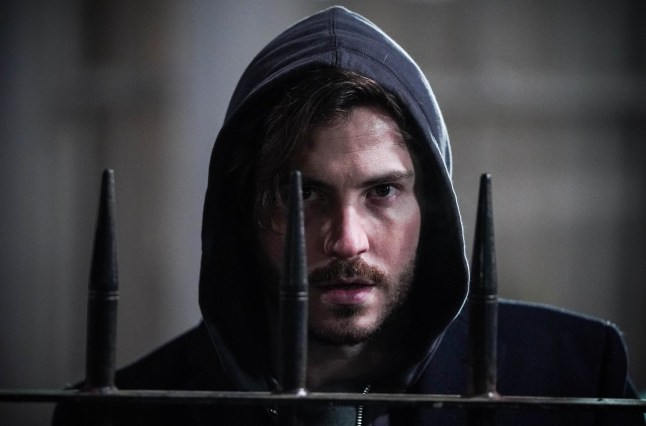 Gray standing beside a fence looking evil in EastEnders