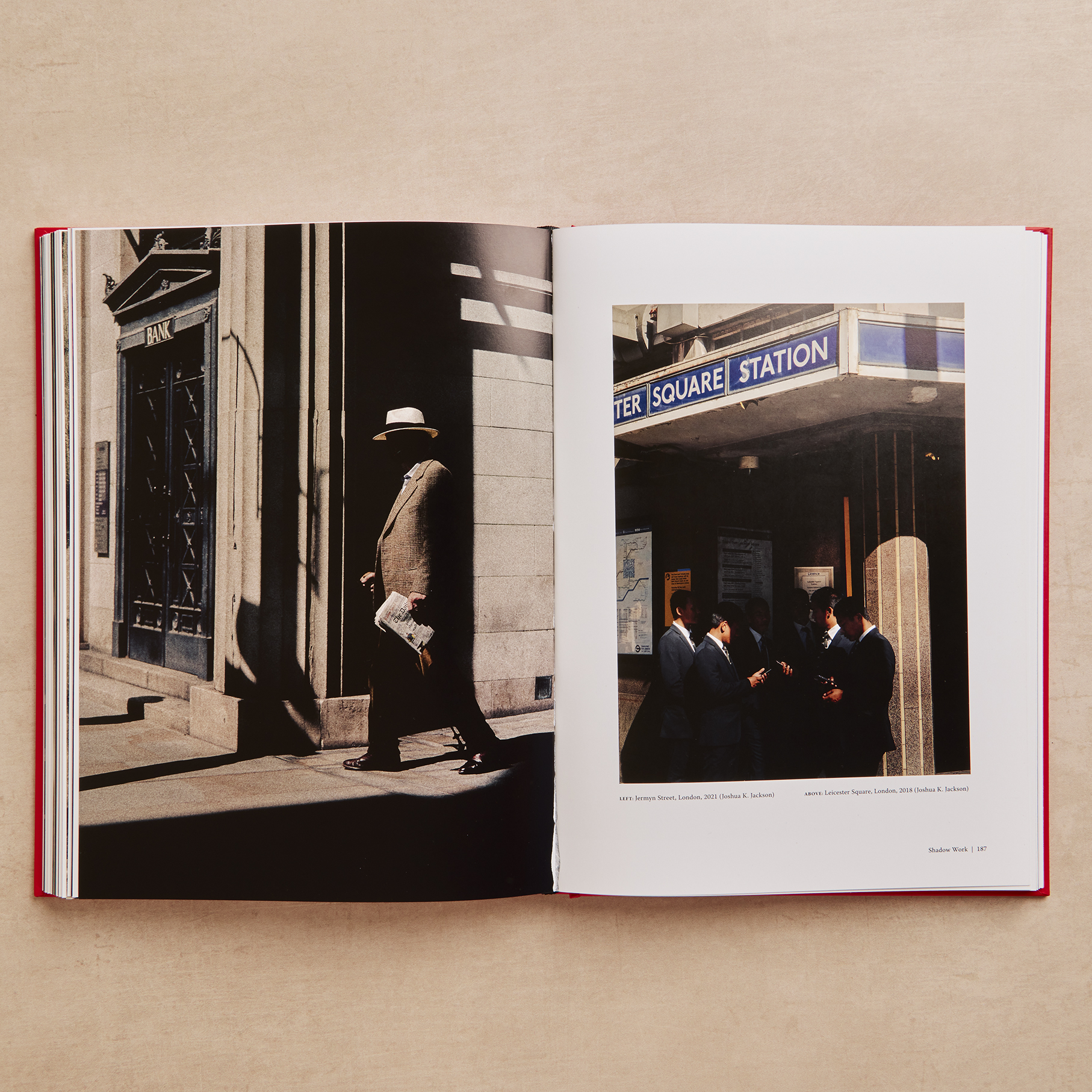 An open hardback copy of The Art of Street Photography showing a spread with a sunlit London street scene on the left and two smaller colour photographs of London locations on the right.