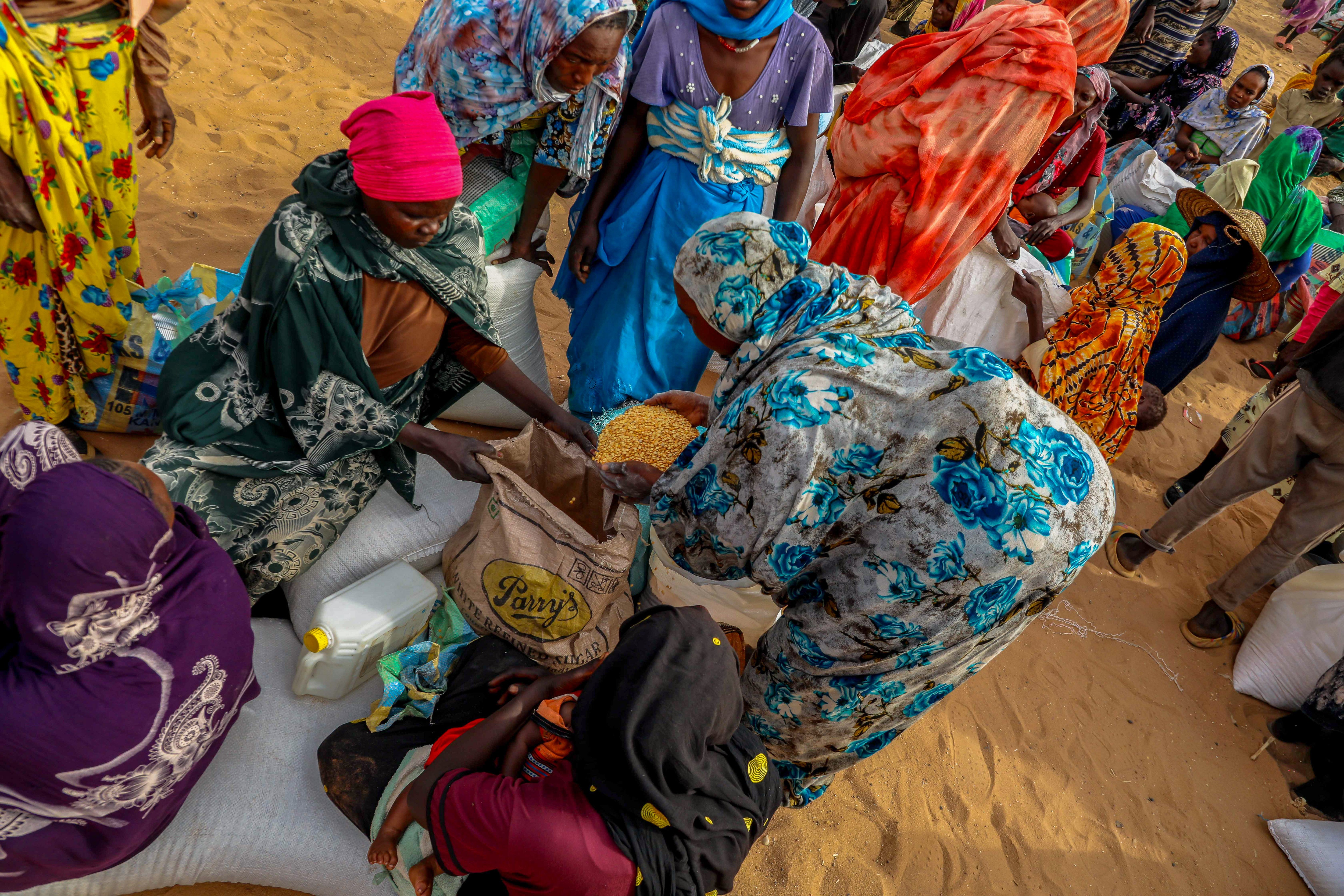 Refugees share the distributed food aid in Ouaddai, Chad. Charities are warning that food crises are likely to worsen in the super El Niño
