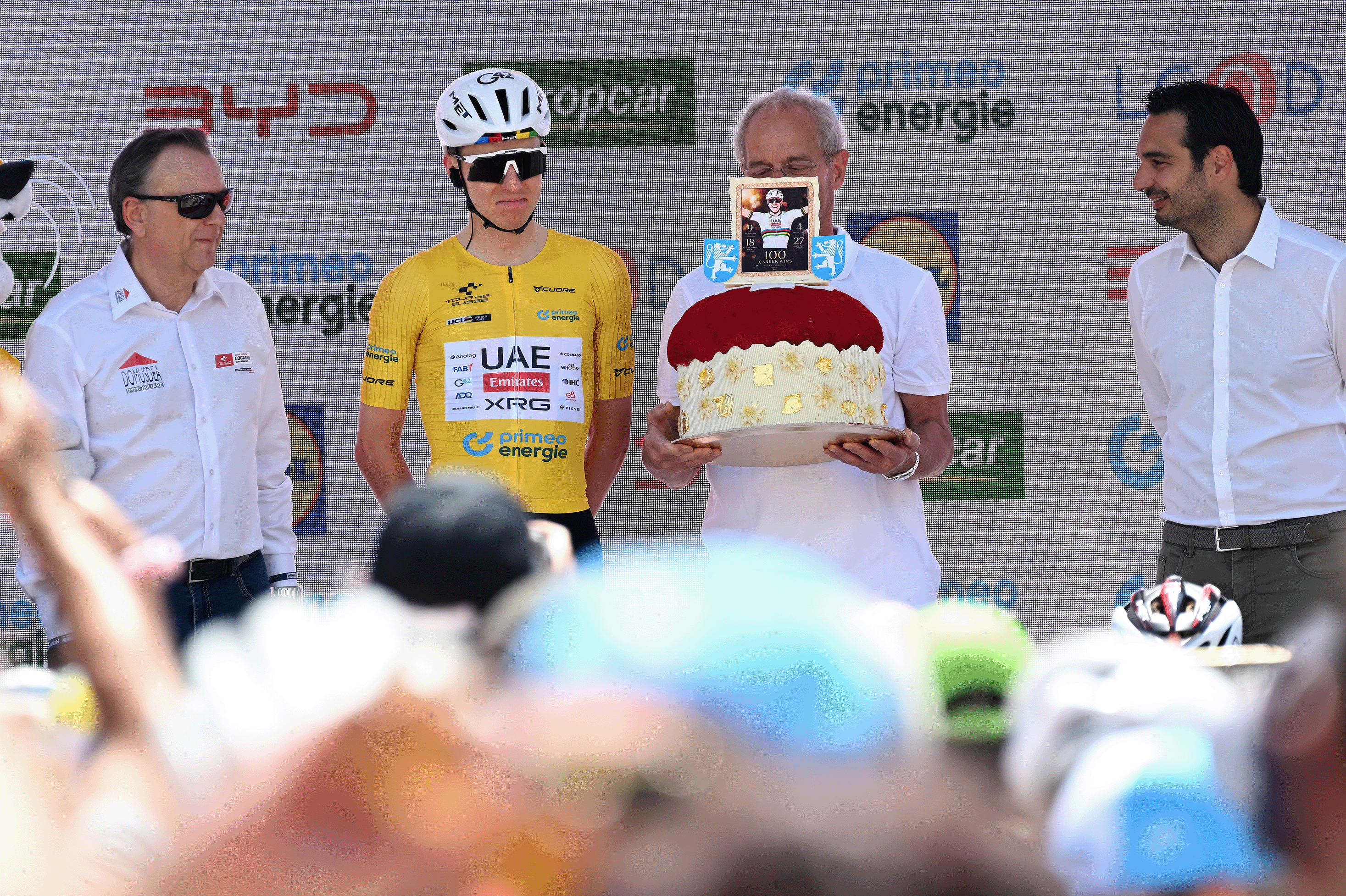 LOCARNO, SWITZERLAND - JUNE 18: Tadej Pogacar of Slovenia and UAE Team Emirates - XRG - Yellow Leader Jersey celebrates at podium as mark of one hundred professional victories, prior to the 89th Tour de Suisse 2026, Stage 2 a 157.7km stage from Locarno to Locarno / #UCIWT / on June 18, 2026 in Locarno, Switzerland. (Photo by Tim de Waele/Getty Images)
