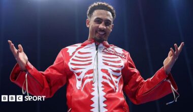 Ben Whittaker wearing a red jacket with a white skeleton pattern on the chest