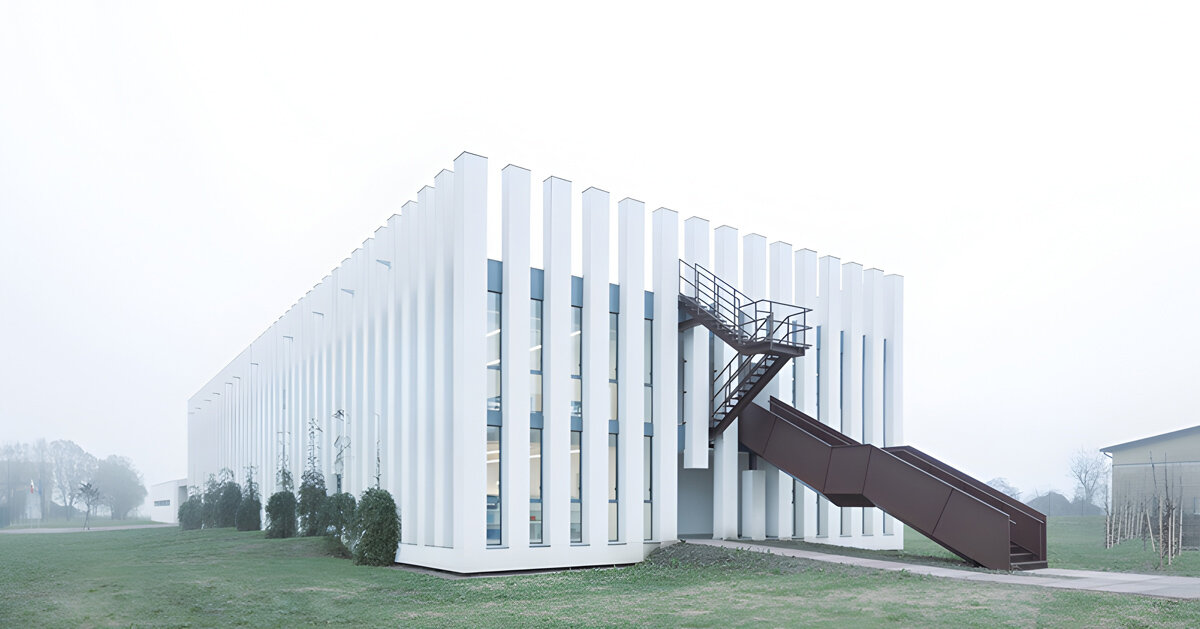 vertical white pillars compose rhythmic school facade in italy
