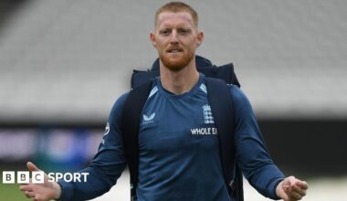 England captain Ben Stokes pictured wearing a backpack and his arms outstretched by his side