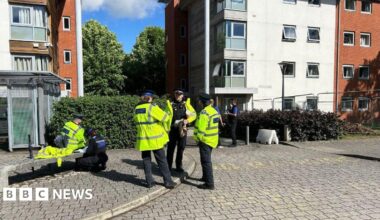 Police officers stood outside a university building.