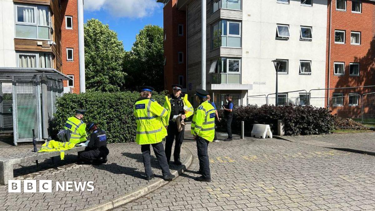 Police officers stood outside a university building.