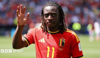 Jeremy Doku waves to the crowd while playing for Belgium