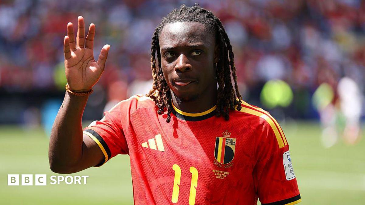 Jeremy Doku waves to the crowd while playing for Belgium