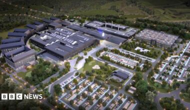 An artist's impression of a hospital, with several buildings, parking spaces and green space
