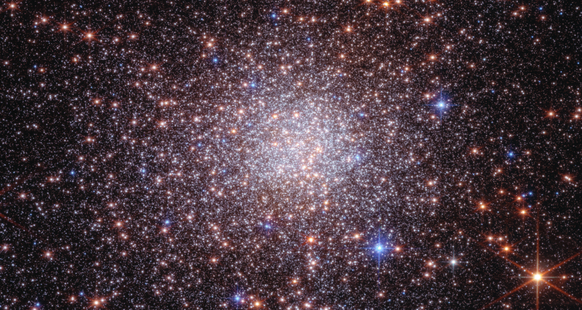 A bunch of stars against a dark background. They're mostly concentrated in the center.