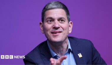 David Miliband speaking on stage