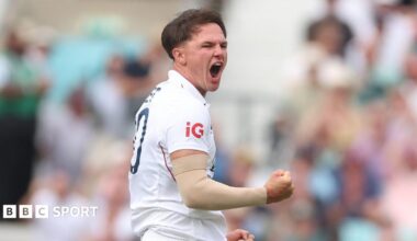 Sonny Baker and Kyle Abbott speak on the cricket field during a County Championship match
