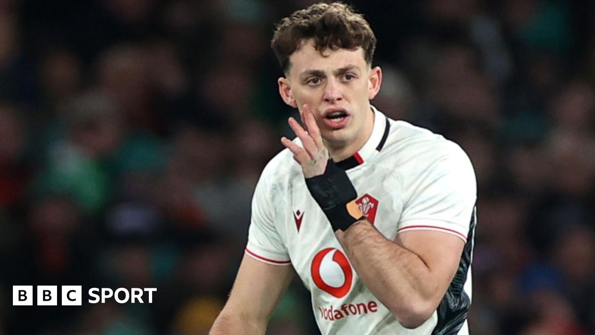 Louie Hennessey shouts with hand to mouth during a Wales game