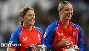 Alice Capsey is hugged by a team-mate