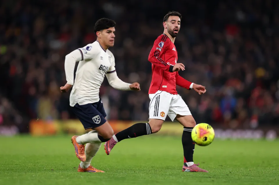 West Ham United's Mateus Fernandes and Manchester United's Bruno Fernandes contest the ball during a Premier League match.