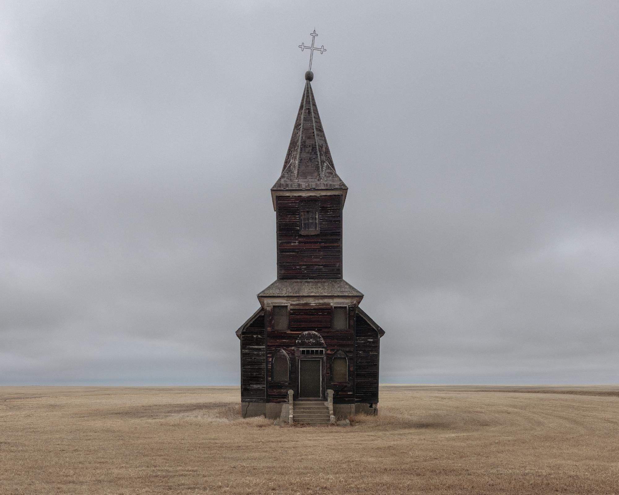 a photograph by Brendon Burton of a derelict church standing alone