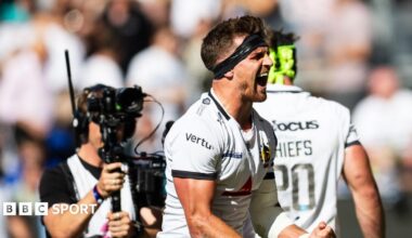 Henry Slade clenches his fist and has his mouth open in celebration
