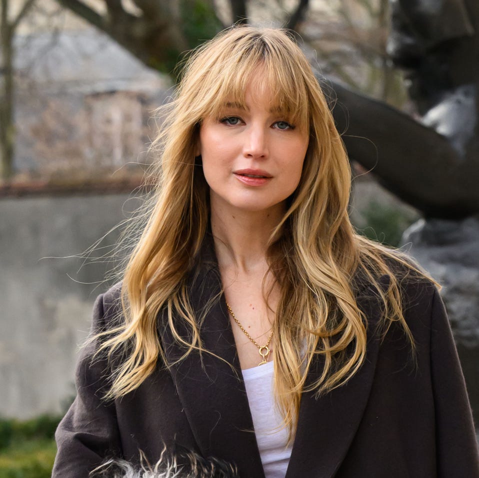 Jennifer Lawrence jennifer lawrence wearing a stylish coat and holding a handbag in an outdoor setting