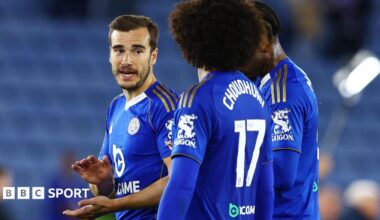 Harry Winks (left) speaking to Leicester City team-mate Hamza Choudhury on the pitch