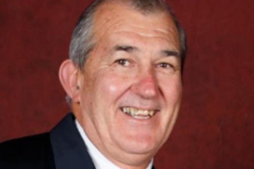 A man smiles at the camera.