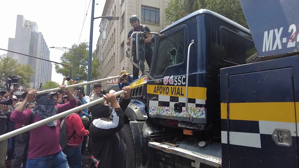 Protestors smash the windows of a Mexico City municipal government tow truck on June 1, 2026.