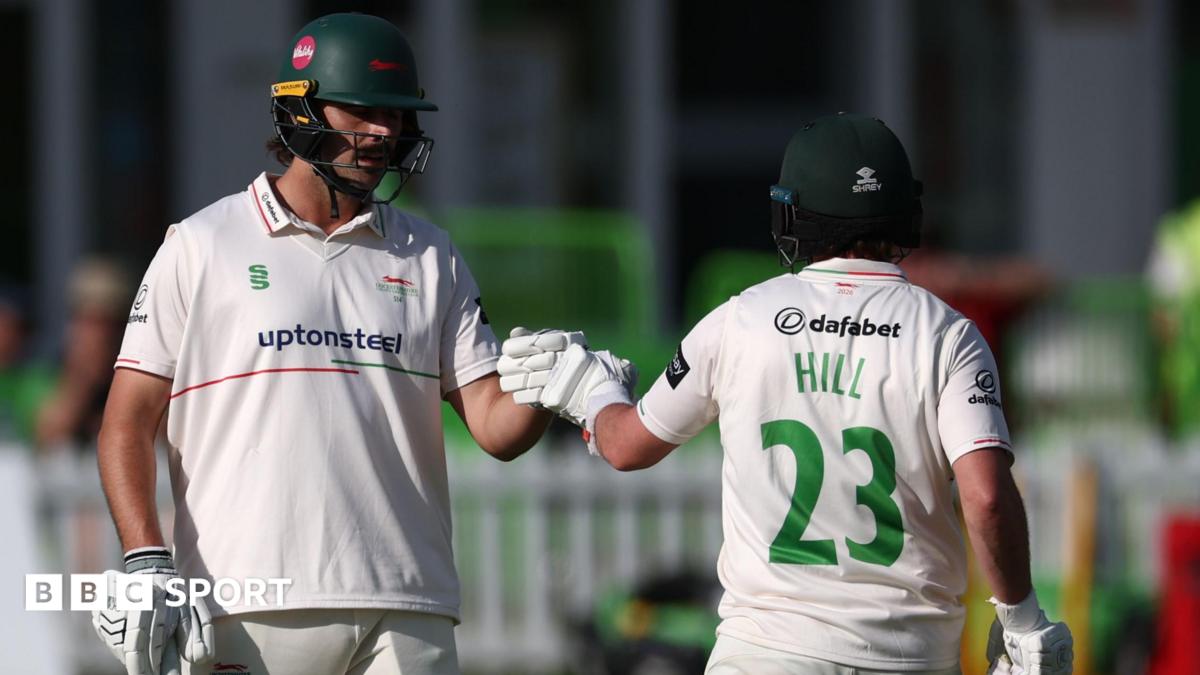 Lewis Hill with HILL 23 in green letters on the back of his white shirt punches gloves with Ben Green (left)