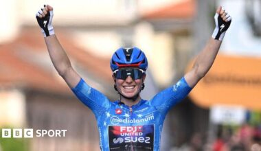 Demi Vollering celebrates at the finish line after clinching the overall victory in the women's Giro d'Italia of 2026