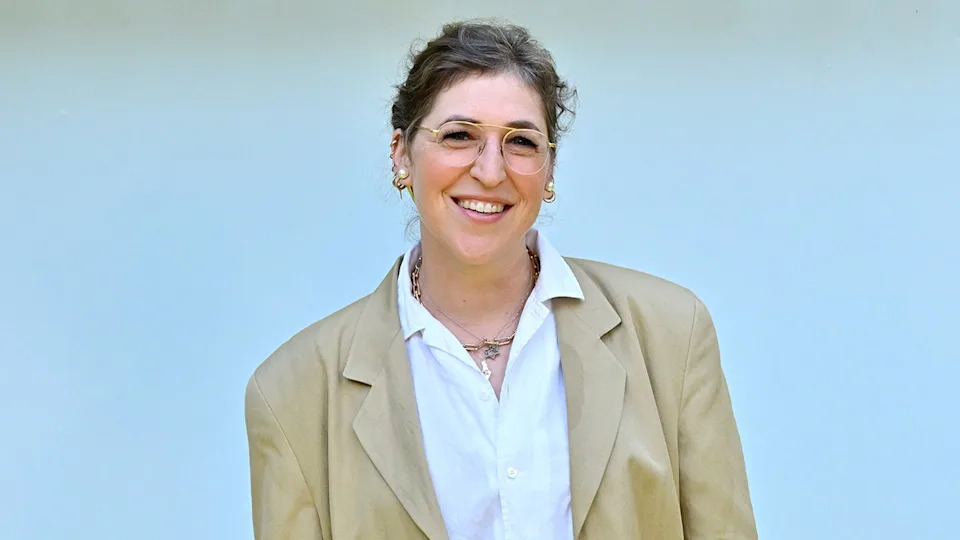 Mayim Bialik smiling on the red carpet at a fan event in Hollywood California