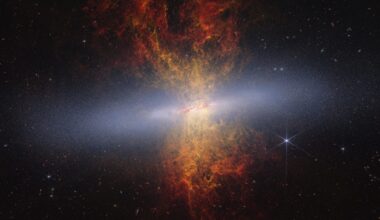 an image of an orange galaxy with a light through it