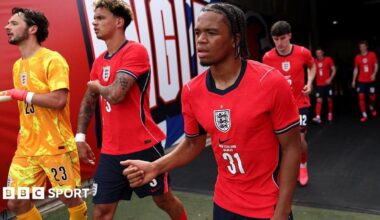 Ngumoha, wearing a red England shirt, walks out of the tunnel for the second half of their game against New Zealand