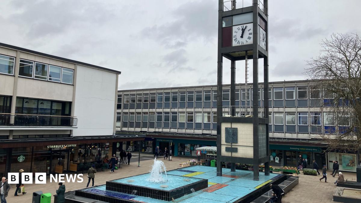 A view of Stevenage town centre showing the clock tower and water feature surrounded by shops