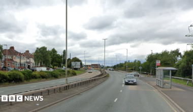 Image shows a dual carriageway, with houses on the left handside and cars travelling down the right hand side