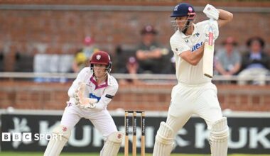 Beau Webster hits out as Somerset wicketkeeper Thomas Rew looks on