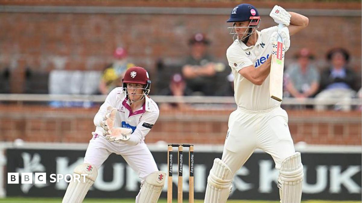 Beau Webster hits out as Somerset wicketkeeper Thomas Rew looks on