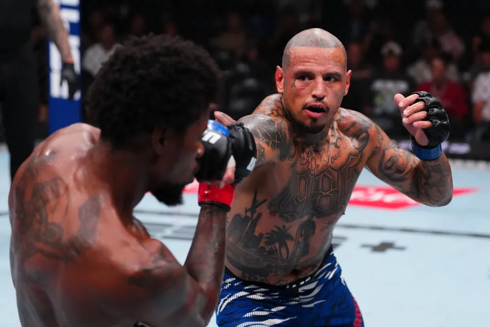 Daniel Rodriguez punches Kevin Holland in a welterweight bout during the UFC 318 event at Smoothie King Center on July 19, 2025 in New Orleans, Louisiana