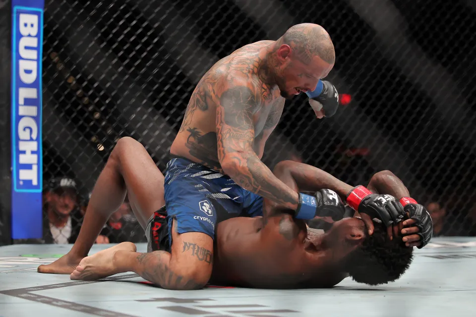 Daniel Rodriguez of the United States strikes Kevin Holland of the United States on the mat during their welterweight bout during UFC 318: Holloway vs Poirier 3 at the Smoothie King Center on July 19, 2025 in New Orleans, Louisiana