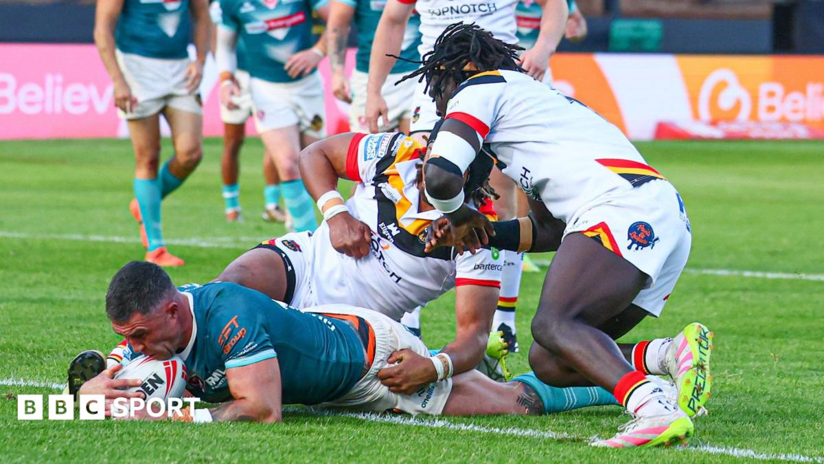 Curtis Sironen (left) has the ball down on the tryline for St Helens with two Bradford defenders on top of him