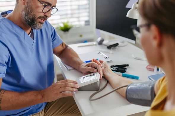 Doctor measuring a patient's blood pressure. Doctor measuring a patient's blood pressure.